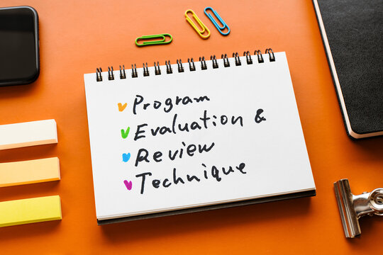 There is notebook with the word Program Evaluation and Review Technique. It is as an eye-catching image.