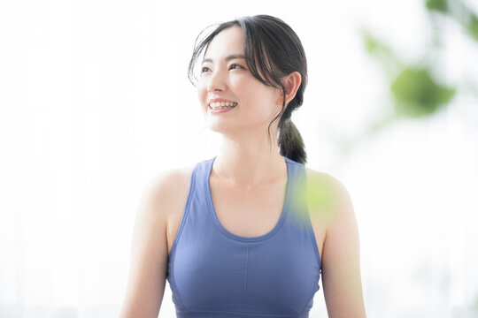 Close-up of a beautiful young woman stretching and exercising Image of sports