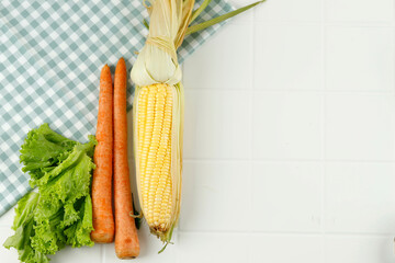 Corn, Carrot, and Lettuce on White Table