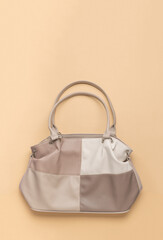 Four-color leather bag on a light background. A place for your text.