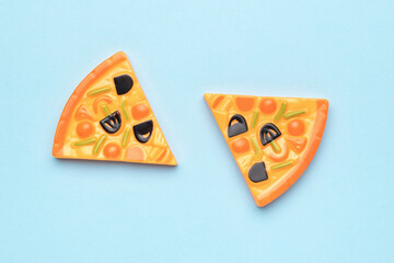 Two pieces of pizza layouts on a blue background.