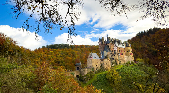 Autumn trees scene with Eltz Castle or Burg Eltz. Medieval castle on the hills above the Moselle River. Rhineland-Palatinate Germany.