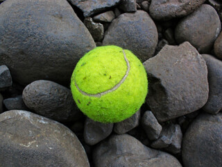 Top view of tennis ball on the gravel. 