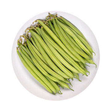Fresh green beans in a white bowl. Young, unripe fruits of a cultivar of the common bean or also French bean, Phaseolus vulgaris. Close-up, isolated, from above, on white background, food photo.