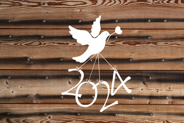 A dove flying the numbers of the new year 2024