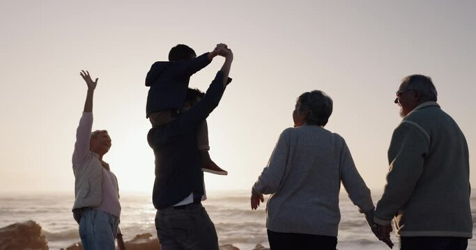 Happy family, holding hands or grandparents at beach for sunset to relax with love or care on holiday vacation. Dad, mom or back of child bonding with grandmother or grandfather at sea for ocean view