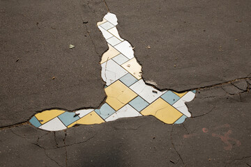 street hole in the sidewalk of the city repaired by an artist with tiling mosaic street art from Lyon city in France