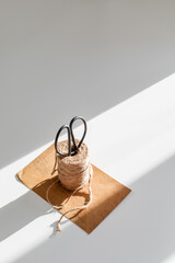 black shears and a bundle or twine