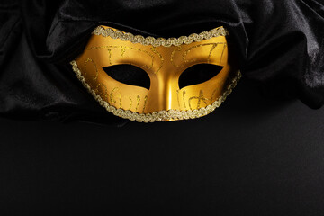 theatrical mask on a black background, copy space