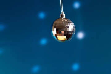 disco ball, glitter shiny christmas decoration with sparkles and mirror reflections, dance floor, blue background