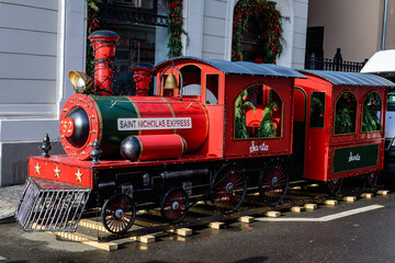 Vivid colorful red Saint Nicholas train decorated for Christmas holiday as seen in the city center...