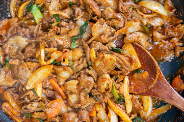 Korean traditional dish of stir-fried pork and assorted vegetables with gochujang - Gochujang Bulgogi