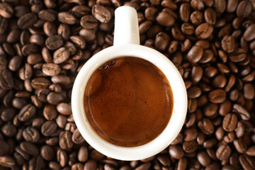 A close up view from directly above a clean white espresso cup filled with a fresh coffee shot....