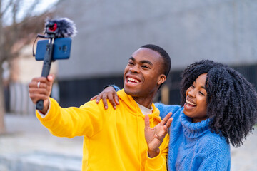 Young african people smiling during a live stream outdoors