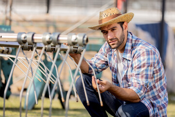 Male farmers wearing plaid shirts and straw hats toured an agricultural machinery expo to gain...
