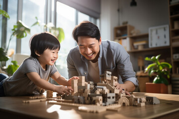 An Asian father and son are assembling a construction set together.