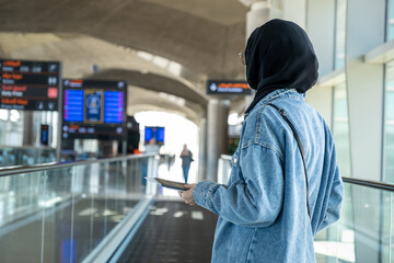 Young arab female holding her passport at the airport ready for new adventure with airplane in the...