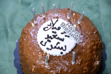 chocolate cake on green background for birthday celebration