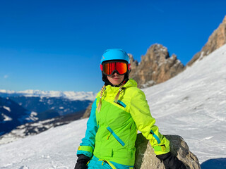 A girl in snowboarding suit in the mountains, hobby and sport time