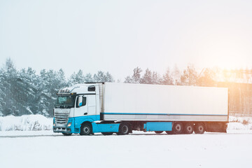 Semi truck on the winter road. A big industrial truck delivering goods in cold weather after the...