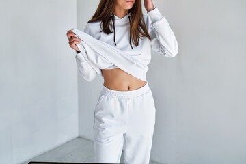 Horizontal isolated photo of an unrecognizable brunette girl wearing a white hoodie. Mock-up of a...