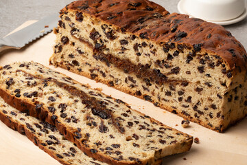 Fresh homemade traditional Dutch Currant bread and cinnamon sugar and slices close up