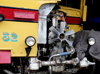 Working on the diesel engine of a vintage publc transport bus.