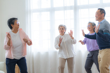 Asian Older male and females people dance with their partners on a dancing floor in living space....