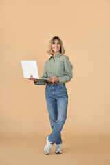 Happy pretty gen z blonde young woman with laptop, smiling student girl with short blond hair holding computer presenting elearning online education standing isolated on beige background. Full length.