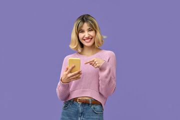 Happy pretty gen z blonde young woman model holding smartphone looking at camera pointing on cell,...