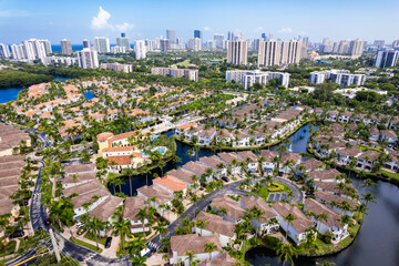 Aerial of Aventura Lakes, a high-end residential community, with skyline of Sunny Isles Beach in...