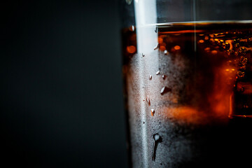 Soda pop with ice in a glass on a white background, delicious drink with ice, cola with ice