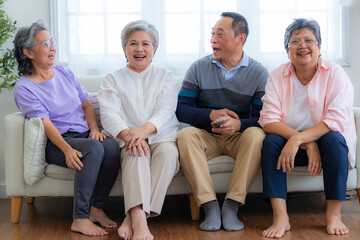 Happiness of the group females and male elderly sitting on the sofa. Senior people are talking and...