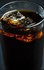 Soda pop with ice in a glass on a white background, delicious drink with ice, cola with ice
