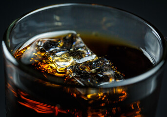 Soda pop with ice in a glass on a white background, delicious drink with ice, cola with ice
