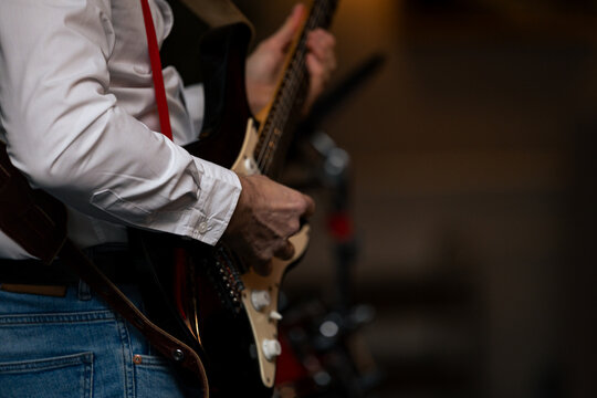 Guitarist hands playing acoustic guitar &ndash; close-up on fingers on strings