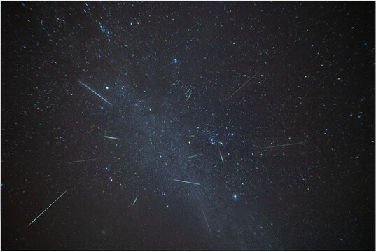 Geminid meteors shower downward in this composite image taken over several hours on a December night in a remote part of Virginia. Constellations: Gem