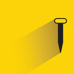 tack and nail with shadow on yellow background