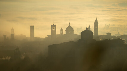 Bergamo, Italy. Amazing aerial landscape of the fog rises from the plains and covers the old town...