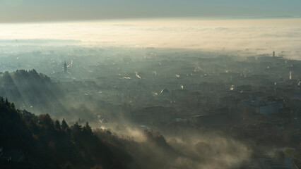 Bergamo, Italy. Amazing aerial landscape of the new town and flat land covered by the humidity and...