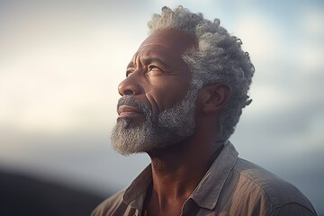 older black man contemplating the landscape seriously and thoughtfully - obrazy, fototapety, plakaty