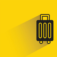 travel bag with shadow on yellow background