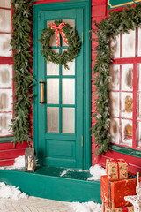 Wreath decoration at door for Christmas holiday.Traditional christmas wreath on old wooden green door in european city street. Stylish christmas street decor, Winter holidays