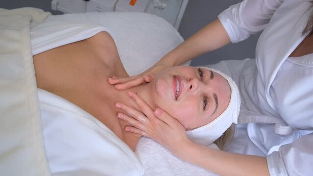 A woman is resting, enjoying a health therapy. Health and beauty. Young woman skin care. Doctor's hand.