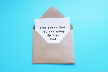 Envelope with card written - I am sorry that you are going through this - concept of Emotional...