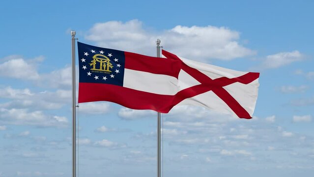 Alabama and Georgia US state flags waving together on cloudy sky, endless seamless loop