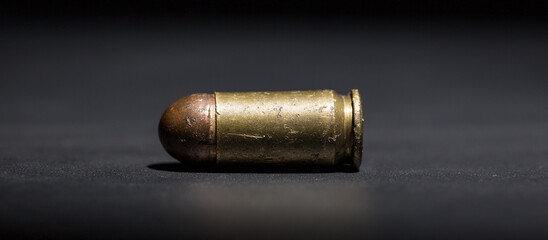 Firearm bullets on a black background, 9mm pistol cartridge