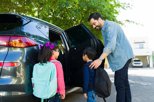 Excited Dad Picking Up Their Kids From School