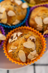 Lemon poppy seed muffins garnished with almond slivers
