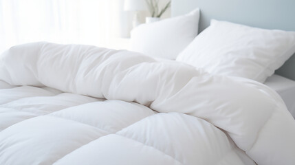 White folded duvet lying on white bed background. Preparing for winter season, household, domestic activities, hotel or home textile, Clean bed sheets 